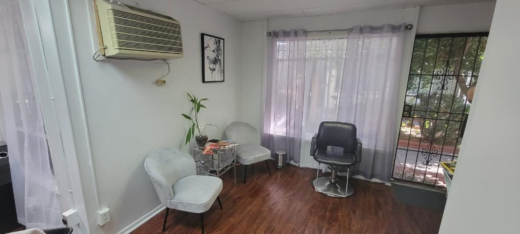 Client waiting area with sheer curtains and natural light