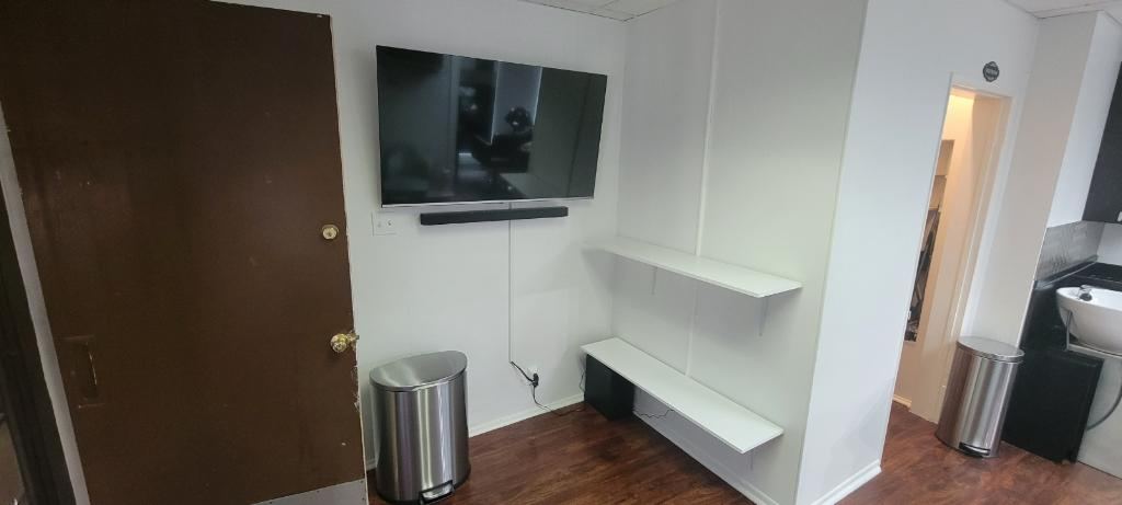 Client lounge with flat-screen TV at Bowie Beauty